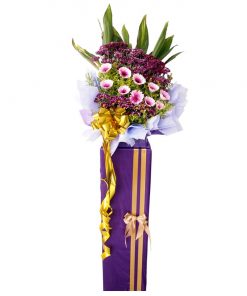 pink gerbera and purple pom opening flower stand