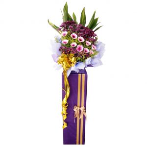 pink gerbera and purple pom opening flower stand